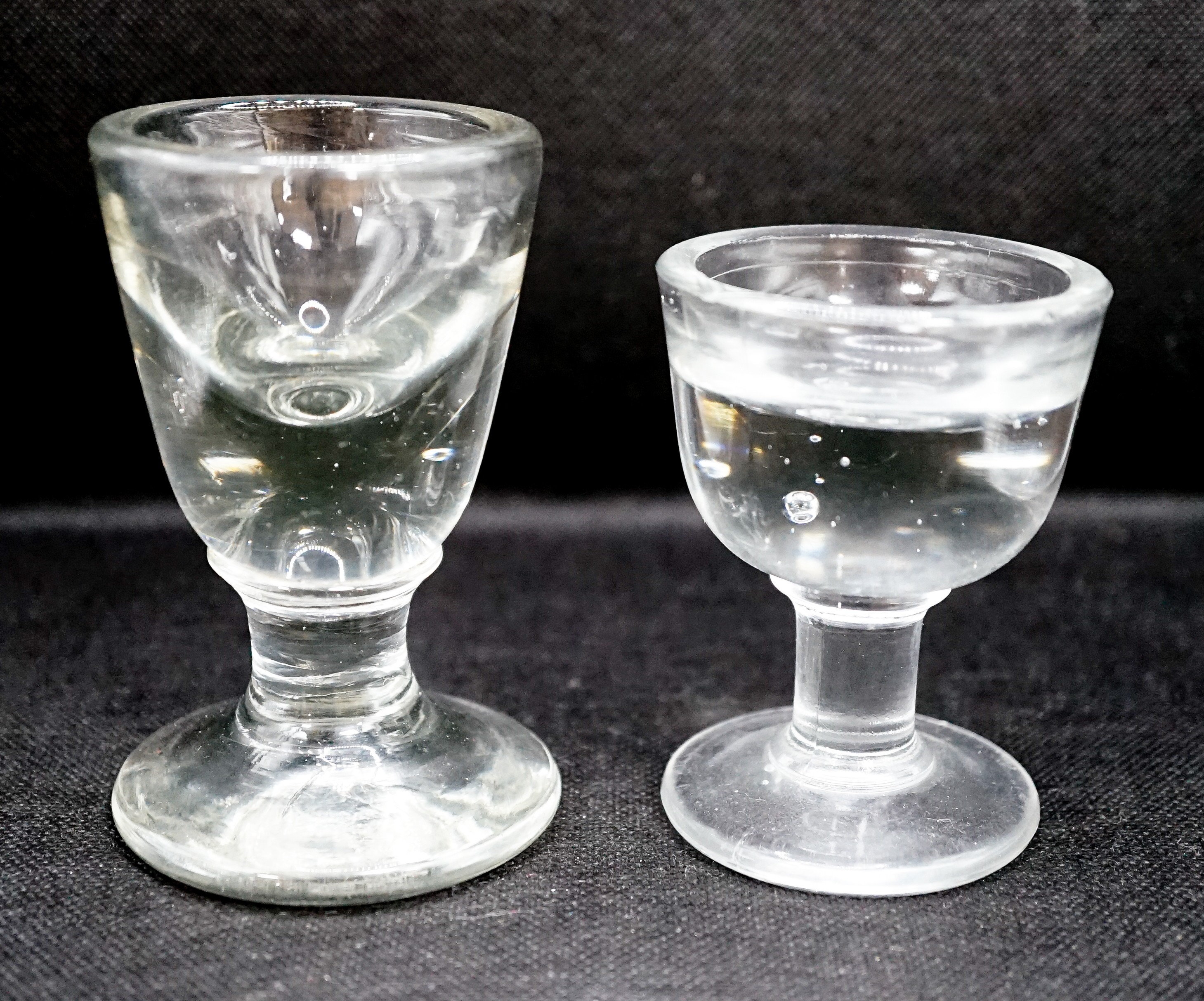 A Georgian deceptive Toastmasters glass and a later penny lick type glass, tallest 10 cm